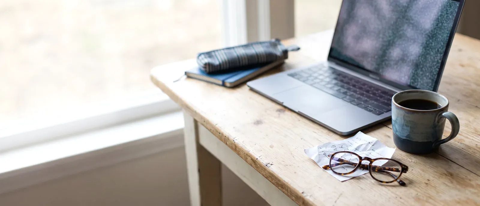 Person ordering PD glasses online on a laptop with a paper prescription beside it